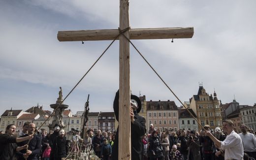 People erect the wooden cross during the Czech Easter rattling ritual to mark Good Friday, that recalls for Christians the crucifixion of Jesus Christ ahead of Easter Sunday. Photo AFP, Michal Cizek