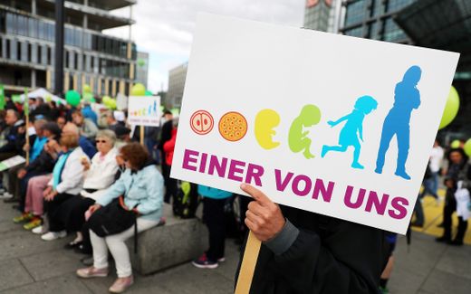 A protestor holds a placard reading 'One of us' during a 'March for Life' demonstration in Berlin. Photo EPA, Felipe Trueba