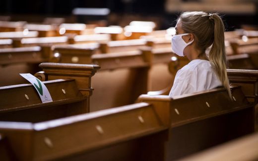 A worshipper wearing a protective face mask while attending a Sunday service at the Berliner Dom cathedral in Berlin amid the Covid-19 coronavirus pandemic. Photo AFP, Odd Andersen
