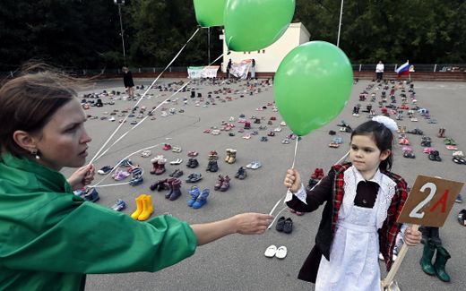 A Russian woman and a little girl participate in a public action themed, 'In defense of human life from the moment of conception (They could go to school)', in Moscow. Activists of the all-Russian public movement 'For Life' exhibit 2,000 pairs of children's shoes, which corresponds to the daily number of abortions in Russia. Photo EPA, Yuri Kochetkov