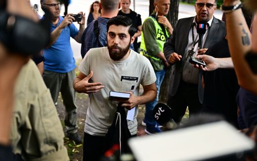 Activist Ahmad Alloush who has been given permission by the police for a public gathering to burn a Torah and a Bible outside the Isaeli embassy, speaks to members of the media. Photo EPA, Magnus Lejhall 
