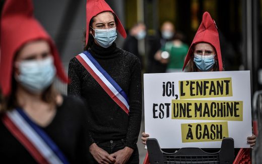 French women protesting against surrogacy. Their banner reads; Here the child is a cash machine. Photo AFP, Stephane de Sakutin