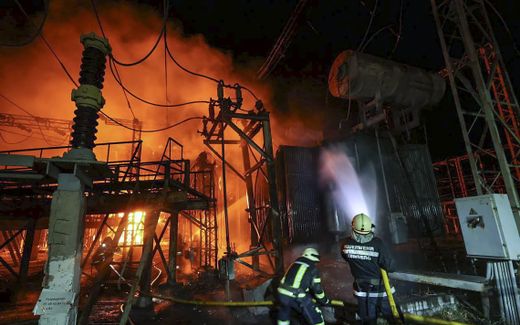Ukrainian rescuers extinguish a fire after a rocket hit an infrastructure object in Kharkiv. Photo EPA, Sergey Kozlov