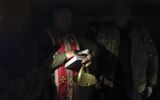 A Military chaplain prays together with Ukrainian soldiers in a shelter not far from their positions at a village not far from Izyum city of Kharkiv area, Ukraine. Currently, most of Ukraine's chaplains work on the battlefield. Photo EPA