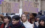 Placards reading "My body my choice" (L) and "Abortion in the Constitution" are seen during a rally to call for the constitutionalisation of the right to abortion outside the Senate in Paris. Photo AFP, Ludovic Marin
