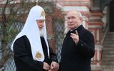Russia's President Vladimir Putin and Russian Orthodox Patriarch Kirill (L) talking during a wreath-laying ceremony at the Monument to Minin and Pozharsky on Red Square on the National Unity Day in Moscow. Photo AFP, Gavriil Grigorov