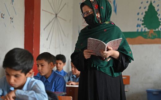 A Muslim teacher conducts a class. Photo AFP, Aamir Qureshi
