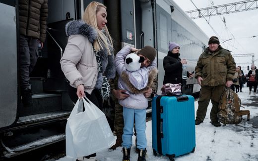 A Ukrainian serviceman, based in Konstantinovka, hugs his daughter, as he welcomes his family after a more than three-month-long separation, at the train station in Kramatorsk. Photo AFP, Yasuyoshi Chiba