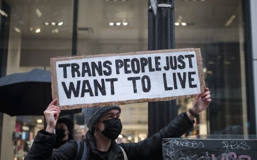 An LGBTQ activist holds a sign reading "Trans People Just Want to Live" during a protest. Photo AFP, Andrej Ivanov AFP