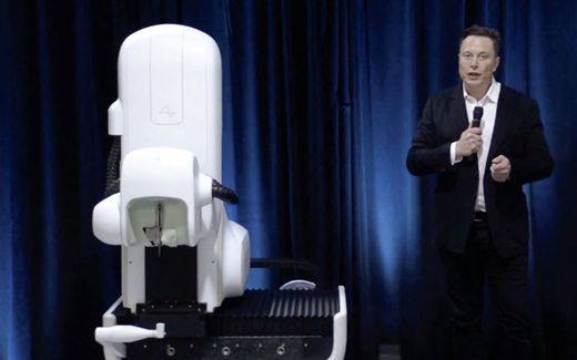 This video grab made from the online Neuralink livestream shows Elon Musk standing next to the surgical robot during a Neuralink presentation on August 28, 2020. Photo AFP, Neuralink