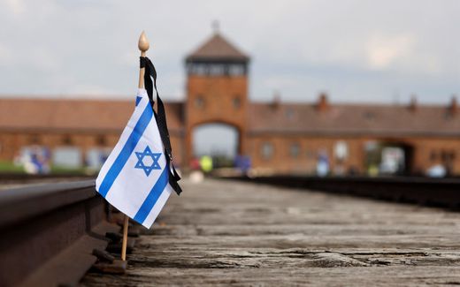 A small national flag of Israel has been placed on the rail tracks at the site of the former Auschwitz-Birkenau camp during commemorations to honour the victims of the Holocaust, near the historical gate of Birkenau (Auschwitz II) near the village of Brzezinka near Oswiecim, Poland. Photo AFP, Wojtek Radwanski
