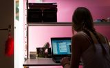 A girl is using her laptop in her bedroom. German principal Silke Müller warns against letting children use smartphones unsupervised in their bedroom. Photo ANP, Roos Koole

