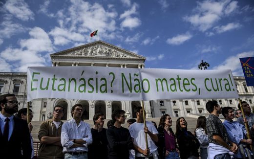 Youngsters hold a banner reading "Euthanasia? Don't Kill, cure!" during a protest against the decriminalization of euthanasia in front of the parliament in Lisbon. Photo AFP, Patricia de Melo Moreira
