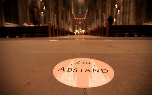 A sticker with the inscription 'Keep 2 meters distance' is seen during a Christmas Eve church service at the Cathedral in Cologne, Germany, 25 December 2020. As the number of cases of the COVID-19 disease caused by the SARS-CoV-2 coronavirus was still rising throughout Germany, the government imposed a second hard lockdown. Photo EPA, Friedemann Vogel