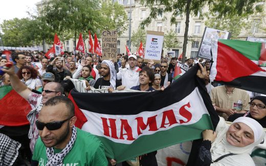 Pro-Palestinian demonstrators hold up the Hamas flag on the Republique square in Paris, ahead of a banned demonstration against Israel's military operation in Gaza and in support of the Palestinian people in 2014. Photo AFP, Kenzo Tribouillard 
