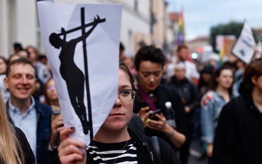 A demonstrator holds up a placard depicting a crucified woman as people take to the streets to protest against the legislation on abortion after the recent death of a pregnant woman in March 2023, in downtown Warsaw, Poland. The Roman Catholic Church in Poland is explicitly pro-life and receives criticism for holding this position. Photo AFP, Wojtek Radwanski