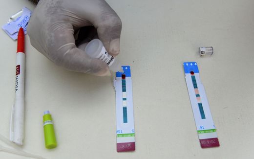 Handling an HIV test in the lab. Photo AFP, Sajjad Hussain