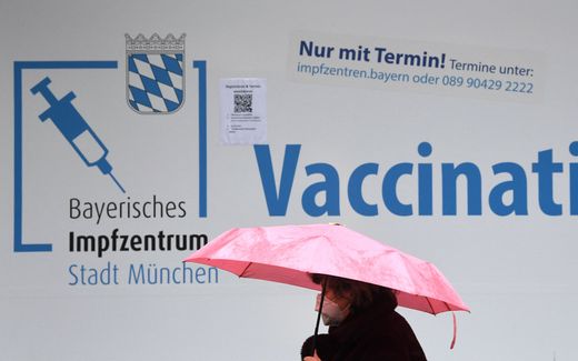 A woman walks past a vaccination center in Munich, amid a surge of infections during the ongoing coronavirus pandemic. Photo AFP, Christof Stache