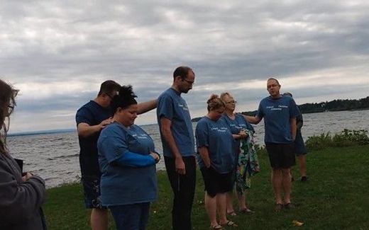 Baptism service at Lake Geneva. Photo YouTube, mrsteresa1999
