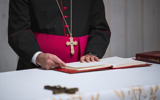 Bishop Saad Sirop Hanna, the apostolic envoy of the Chaldean church in Europe, reads inside a church in the eastern town of Sodertalje, south of Stockholm. Photo AFP, Jonathan Nackstrand