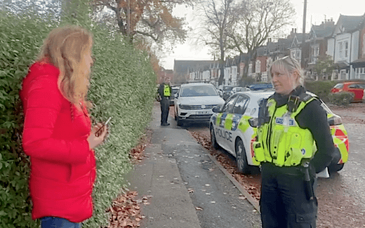 Isabel Vaughan-Spruce (left) approached by an English police agent because of silent prayer in the neighbourhood of an abortion clinic. Still from video at X.com